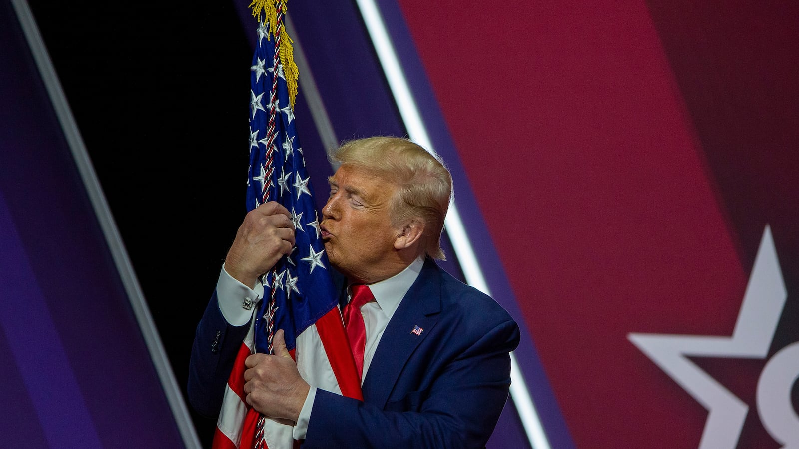 NATIONAL HARBOR, MARYLAND - FEBRUARY 29: President Donald Trump kisses the flag of the United States of America at the annual Conservative Political Action Conference (CPAC) at Gaylord National Resort & Convention Center February 29, 2020 in National Harbor, Maryland. Conservatives gather at the annual event to discuss their agenda. (Photo by Tasos Katopodis/Getty Images)
