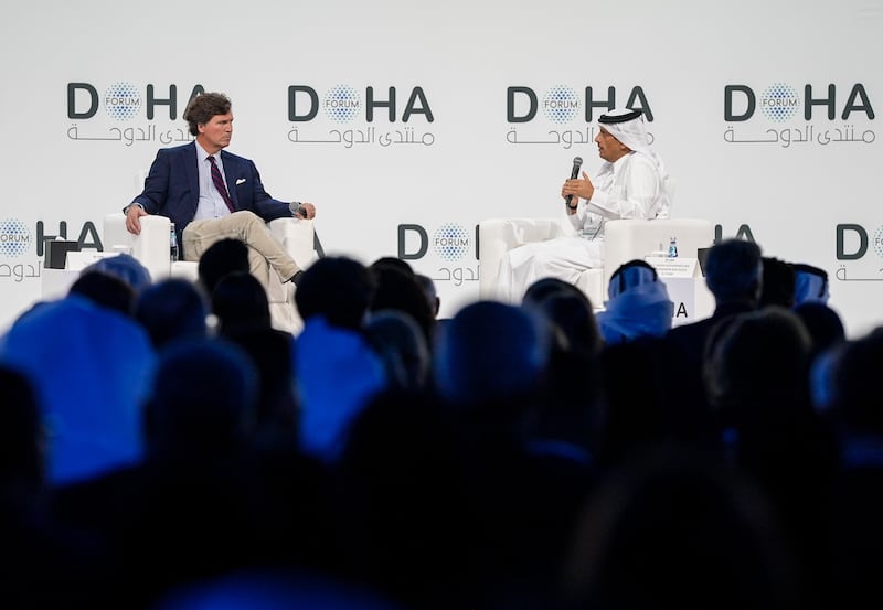 Qatari Prime Minister and Foreign Minister Mohammed bin Abdulrahman Al Thani (R) answers questions from journalist Tucker Carlson (L) during the 'Newsmaker Interview' session held as part of the Doha Forum 2025 in Doha, Qatar on December 07, 2025.