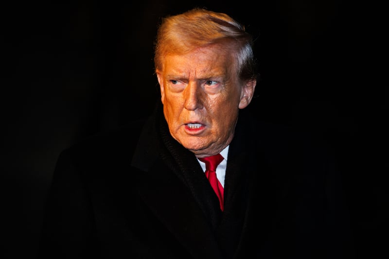 President Donald Trump walks over to reporters to make a brief statement before departing from the South Lawn of the White House in Marine One on January 20, 2026 in Washington, DC.