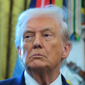 U.S. President Donald Trump listens during a ceremony for the presentation of the Mexican Border Defense Medal in the Oval Office of the White House on December 15, 2025 in Washington, DC.