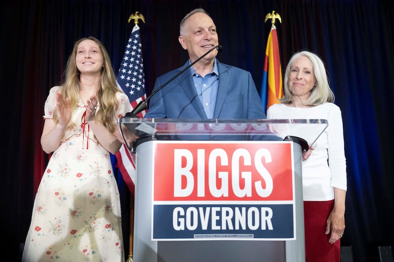 U.S. Representative and Republican nominee for Arizona governor Andy Biggs celebrates his win with his daughter, Mylie, and wife, Cindy, during his primary election night watch party at Dillon Precision in Scottsdale, Arizona, U.S. July 21, 2026.  REUTERS/Rebecca Noble