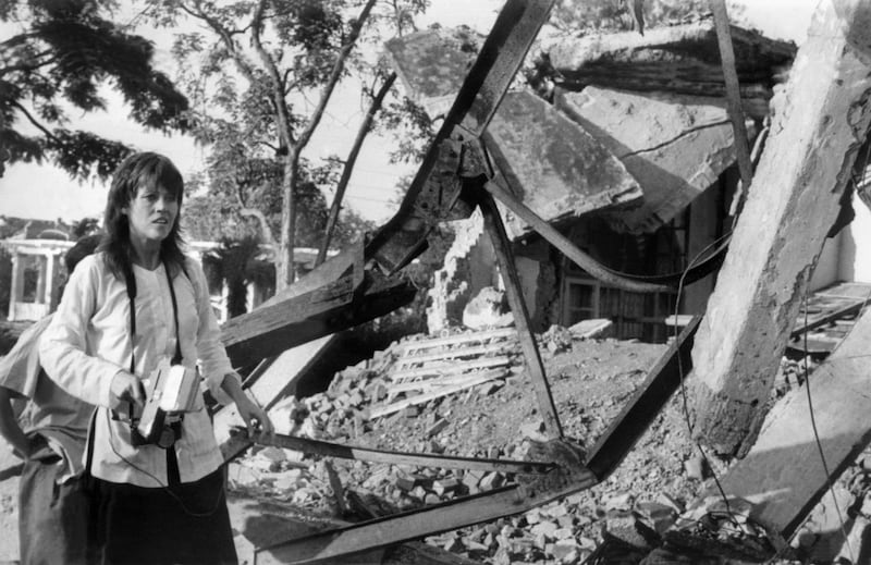 HANOI, VIET NAM: US actress and peace activist Jane Fonda, holding a camera, visits 25 July 1972 a Hanoi site bombed by US airplanes. Fonda's trip to North Vietnam was part of her protest campaign against the US involvement in the Vietnam war. US bombers, including B-52 strato-fortresses, started to bomb the North Vietnamese capital and its port Haiphong in April 1972. (Photo credit should read AFP via Getty Images)