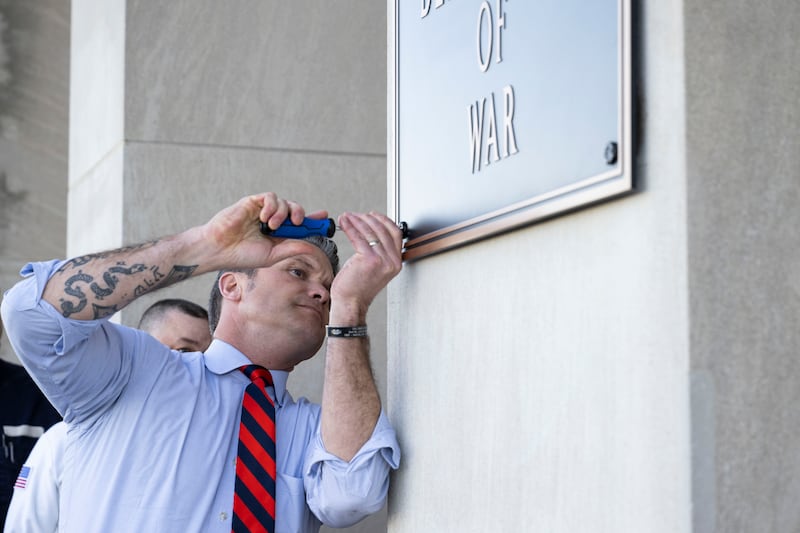 Secretary of War Pete Hegseth finishes the installation of a Department of War plaque at the River Entrance in front of the Pentagon, Washington, D.C., Nov. 13, 2025.