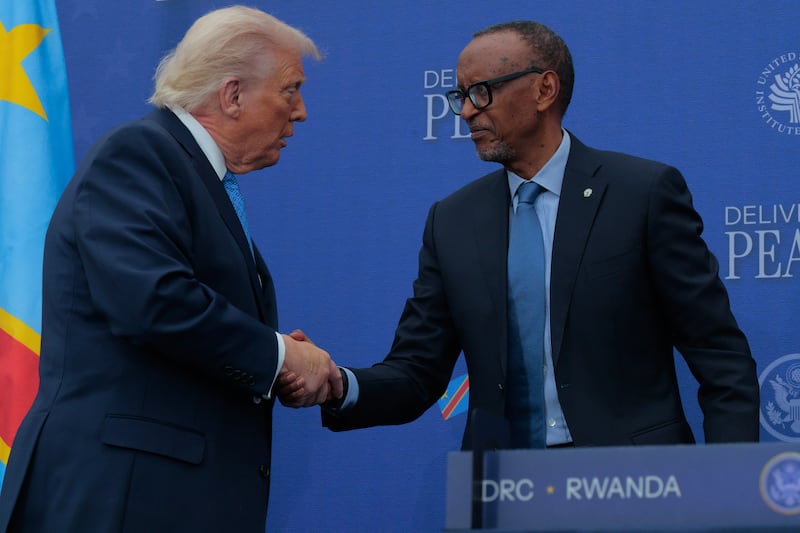President Donald Trump (C) poses for photographs with Rwandan President Paul Kagame (L) and Democratic Republic of Congo President Felix Tshisekedi after signing a peace accord at the Donald J. Trump Institute of Peace on December 04, 2025 in Washington, DC.