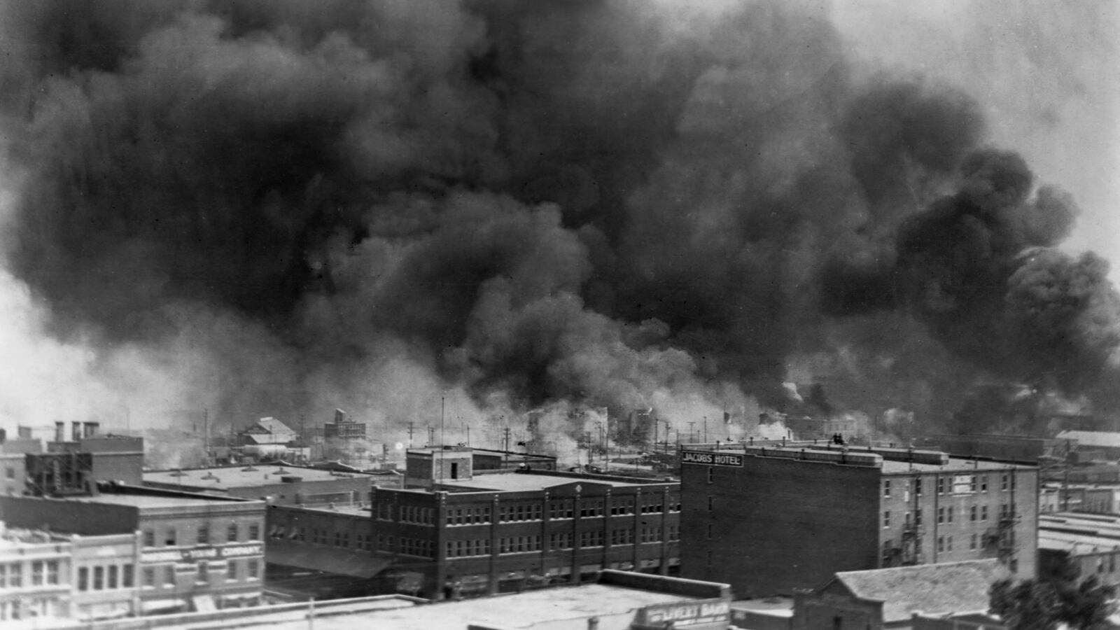 Black smoke billows from fires during the Tulsa Race Massacre of 1921