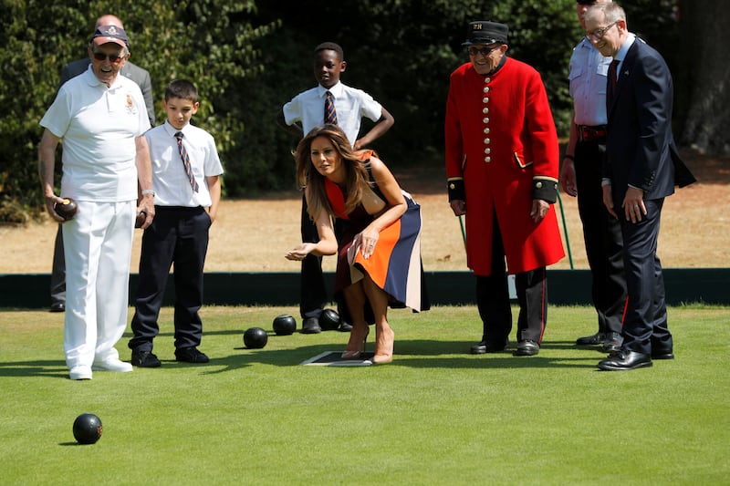 U.S. First Lady Melania Trump and Philip May, the husband of Britain's Prime Minister Theresa May, take part in a game of bowls with veterans and schoolchildren during a visit to the Royal Hospital Chelsea in London, Britain, July 13, 2018.
