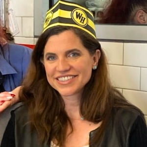 Nancy Mace wearing a Waffle House paper cap.