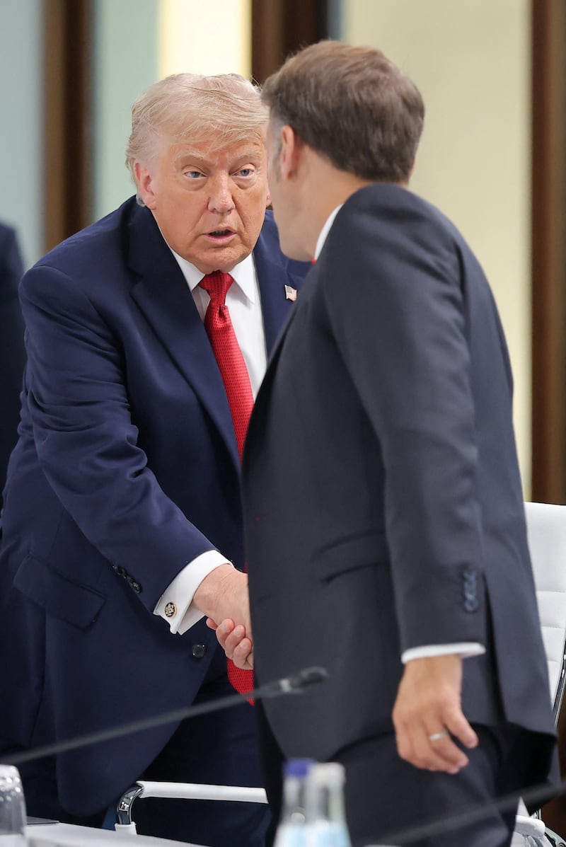 U.S. President Donald Trump and French President Emmanuel Macron shake hands as they attend a working session with G7 leaders and outreach partners on promoting economic growth, during the G7 Summit in Evian-les-Bains, France, June 17, 2026. REUTERS/Christian Hartmann