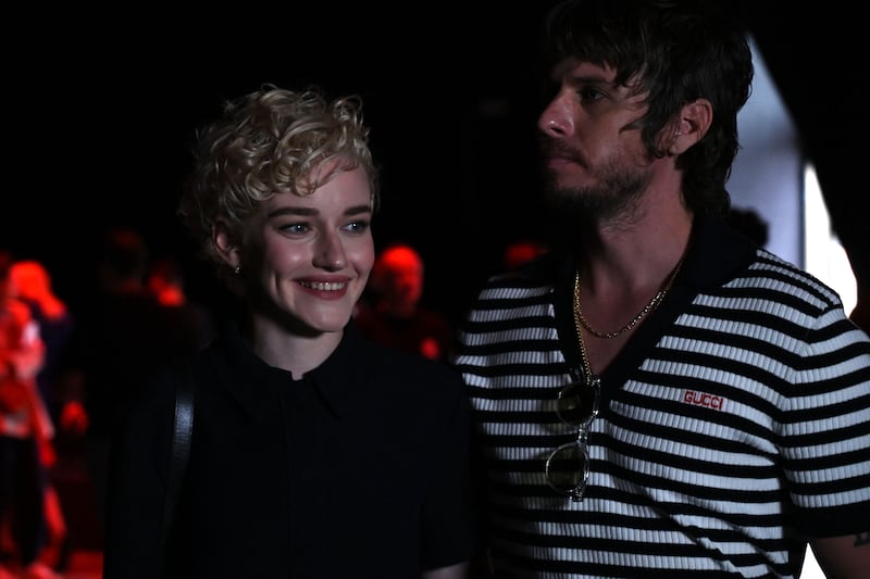 US actress Julia Garner and husband Mark Foster are pictured before the start of the Gucci fashion show during the Milan Fashion Week Womenswear Spring/Summer 2024 on September 22, 2023, in Milan.
