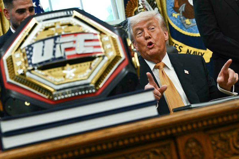 A UFC championship belt is displayed as US President Donald Trump speaks about the upcoming "UFC Freedom 250" event, in the Oval Office of the White House on May 6, 2026, in Washington, DC. An Ultimate Fighting Championship event will be staged on the White House's South Lawn in June. The June 14 event has been dubbed "UFC Freedom 250," in reference to the United States' 250th anniversary celebrations this summer. (Photo by Kent NISHIMURA / AFP via Getty Images)