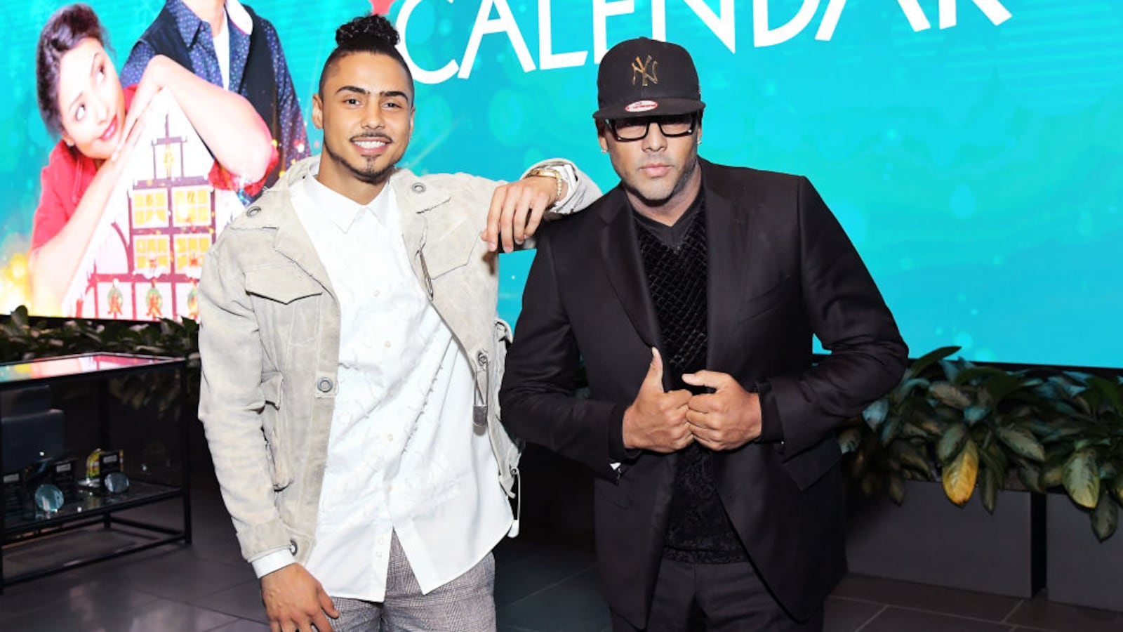 Quincy Brown, left, and Al B. Sure!, right, pose together on stage.