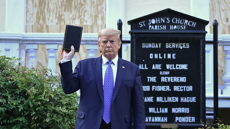 President Donald Trump holds up a Bible outside of St John's Episcopal church across Lafayette Park in Washington, DC on June 1, 2020.