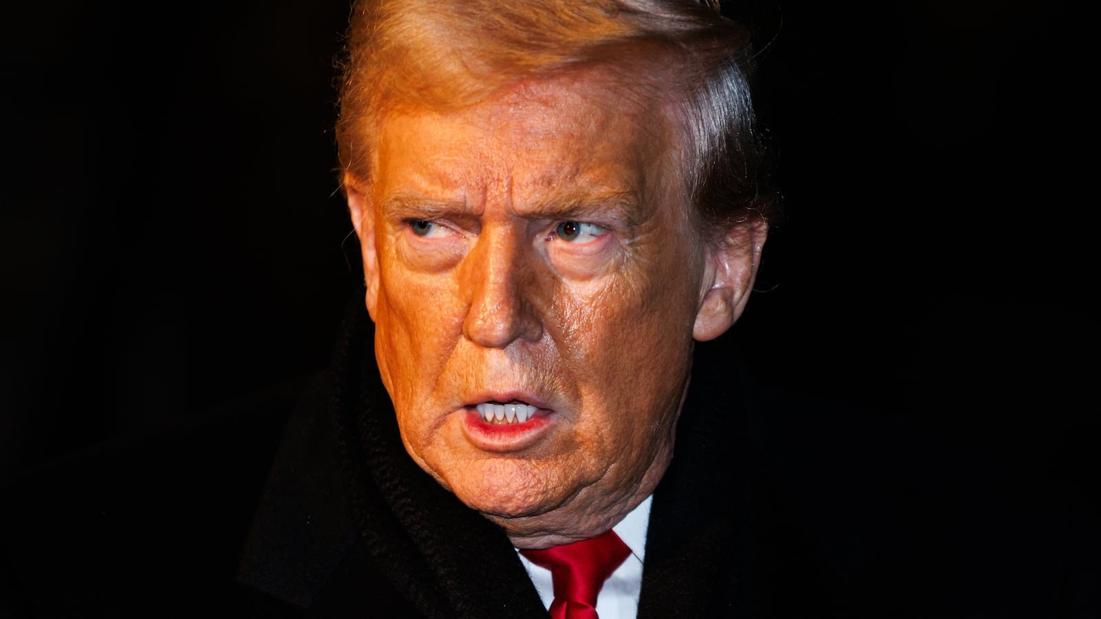 President Donald Trump walks over to reporters to make a brief statement before departing from the South Lawn of the White House in Marine One on January 20, 2026 in Washington, DC.