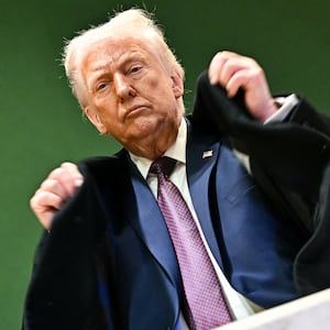 U.S. President Donald Trump adjusts his jacket as he leaves the Congress Centre during the World Economic Forum (WEF) annual meeting in Davos on January 22, 2026.