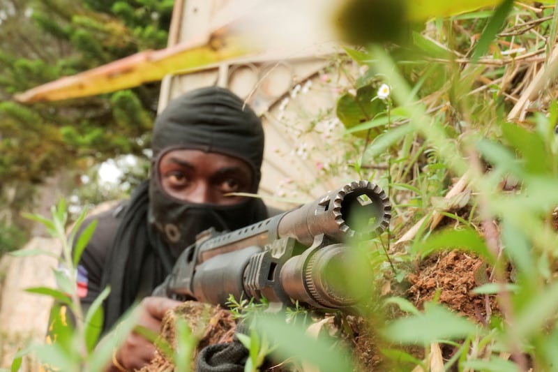 A neighbourhood watch member poses for a photograph while patrolling with others at a residential area after gangs torched homes, amid a surge in violence that has displaced approximately 1.3 million people in six months, according to U.N. estimates, in Furcy, Haiti June 24, 2025. REUTERS/Jean Feguens Regala