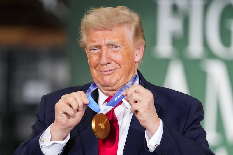 U.S. President Donald Trump holds a gold Olympic medal belonging to U.S. speed skater and Wisconsin native Jordan Stolz during an event at Custer Farms in Chippewa Falls, Wisconsin, U.S., June 5, 2026.