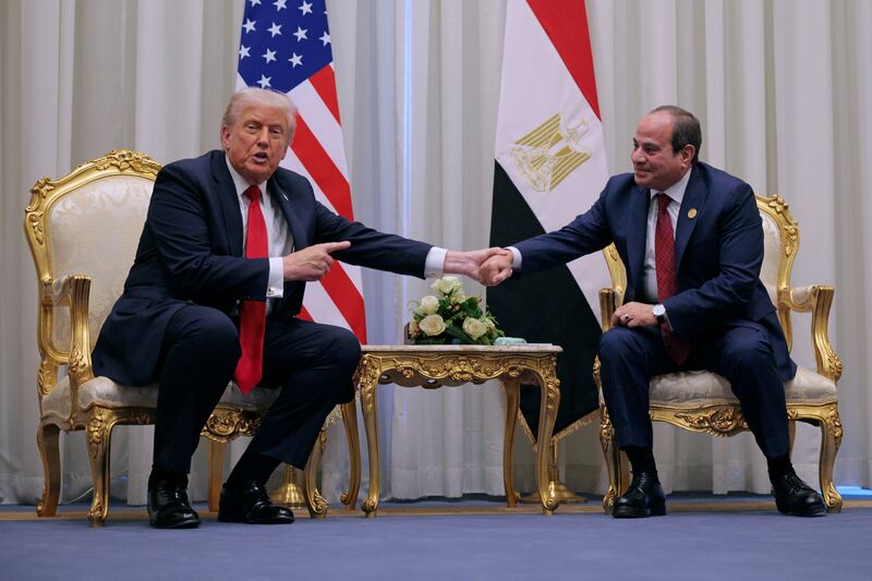 U.S. President Donald Trump and President of Egypt Abdel Fattah El-Sisi shake hands while speaking to the press during a Middle East peace summit at the Sharm El Sheikh International Congress Center October 13, 2025 in Sharm El-Sheikh, Egypt.