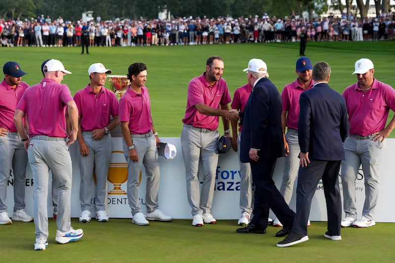 Scottie Scheffler of the U.S. Team shakes hands with U.S. President Donald Trump after the U.S. Team defeated the International Team, 17-13, to win the Presidents Cup at Medinah Country Club Course No. 3 on September 27, 2026 in Chicago, Illinois.