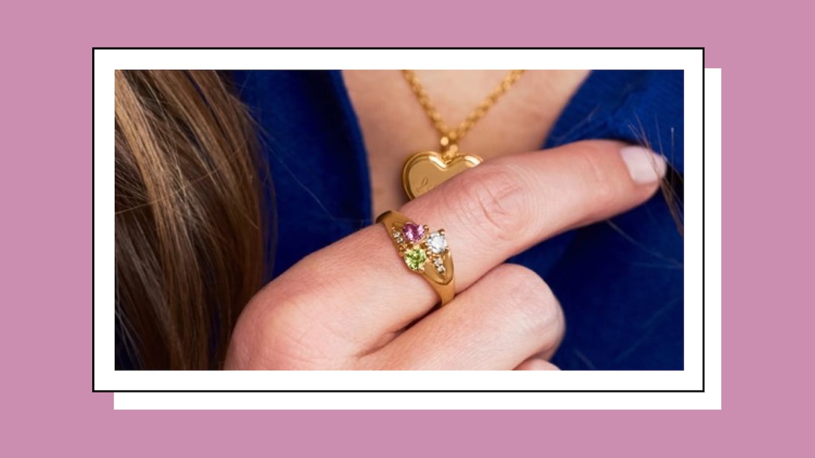 Close up on a woman wearing a three-gem ring and heart-shaped pendant by JEWLR.