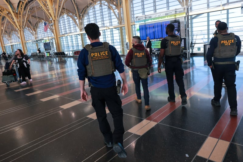 U.S. Immigration and Customs Enforcement (ICE) agents patrol at Washington Reagan National Airport in Arlington, Virginia, U.S., March 24, 2026.