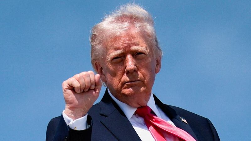 U.S. President Donald Trump makes a fist as he boards Air Force One for his trip to Las Vegas, Nevada, as he departs Joint Base Andrews, Maryland, U.S., on the day he announced that Israeli and Lebanese leaders had agreed to begin a 10-day ceasefire, April 16, 2026. REUTERS/Evan Vucci