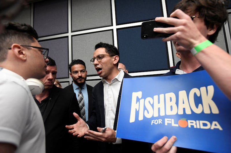 Republican Florida gubernatorial candidate James Fishback talks with a college student after giving a campaign speech at the University of Central Florida in Orlando, Florida, U.S. April 23, 2026.