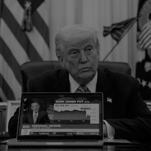 US President Donald Trump plays a CNBC news clip on a laptop