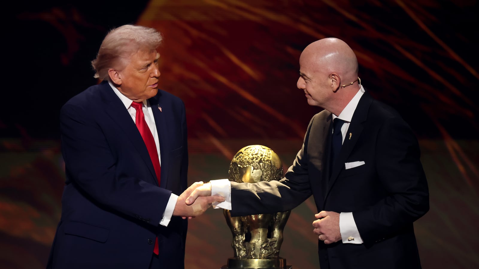 FIFA President Gianni Infantino shakes hands with President Donald Trump as he receives the inaugural FIFA Peace Prize during the FIFA World Cup 2026 Official Draw at John F. Kennedy Center for the Performing Arts on December 05, 2025.