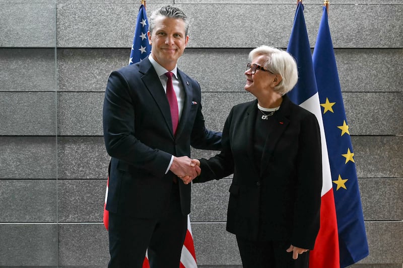 French Minister of the Armed Forces and Veterans Catherine Vautrin (R) welcomes US Secretary of War Pete Hegseth ahead of a ceremony marking the 82nd anniversary of the D-Day landings at the Normandy American Cemetery in Colleville-sur-Mer, northwestern France, on June 6, 2026. (Photo by LOU BENOIST / AFP via Getty Images) / QUALITY REPEAT