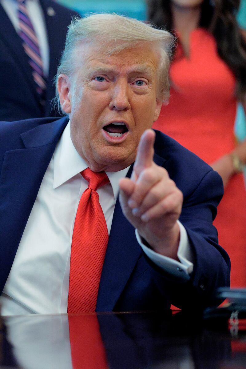 President Donald Trump talks to journalists after signing executive orders in the Oval Office at the White House on August 25, 2025 in Washington, D.C.