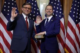 U.S. Speaker of the House Rep. Mike Johnson (R-LA) (L) participates in a ceremonial swearing-in with Rep. Jared Moskowitz (D-FL) (R) at the U.S. Capitol
