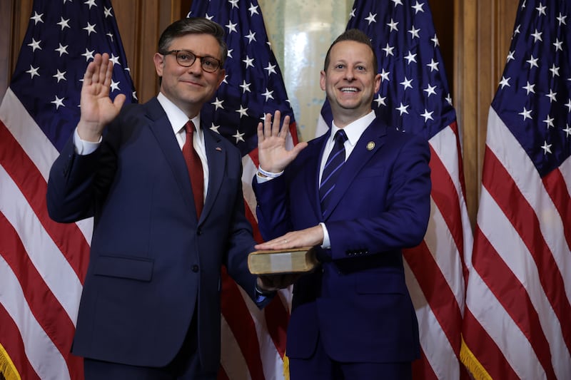 U.S. Speaker of the House Rep. Mike Johnson (R-LA) (L) participates in a ceremonial swearing-in with Rep. Jared Moskowitz (D-FL) (R) at the U.S. Capitol