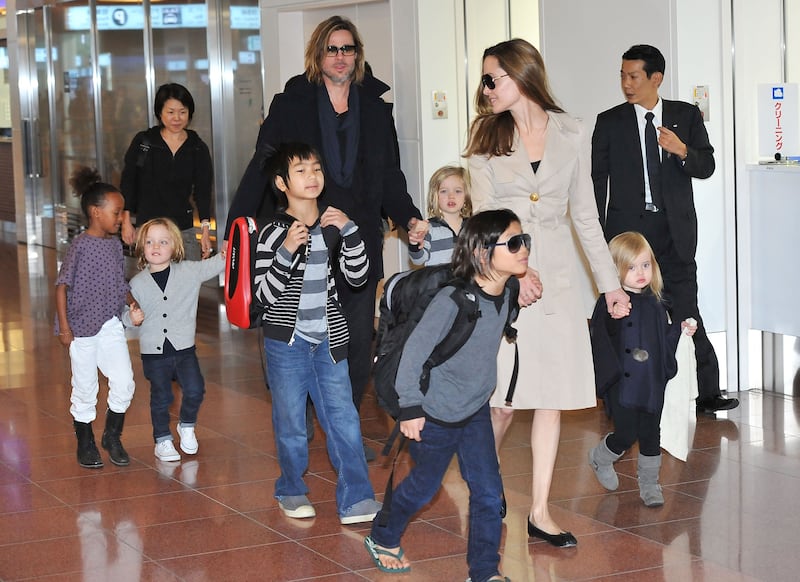 Brad Pitt, Angelina Jolie, and their six children, Maddox, Pax, Zahara, Shiloh, Knox, and Vivienne, arrive at Haneda International Airport on November 8 in Tokyo, Japan.
