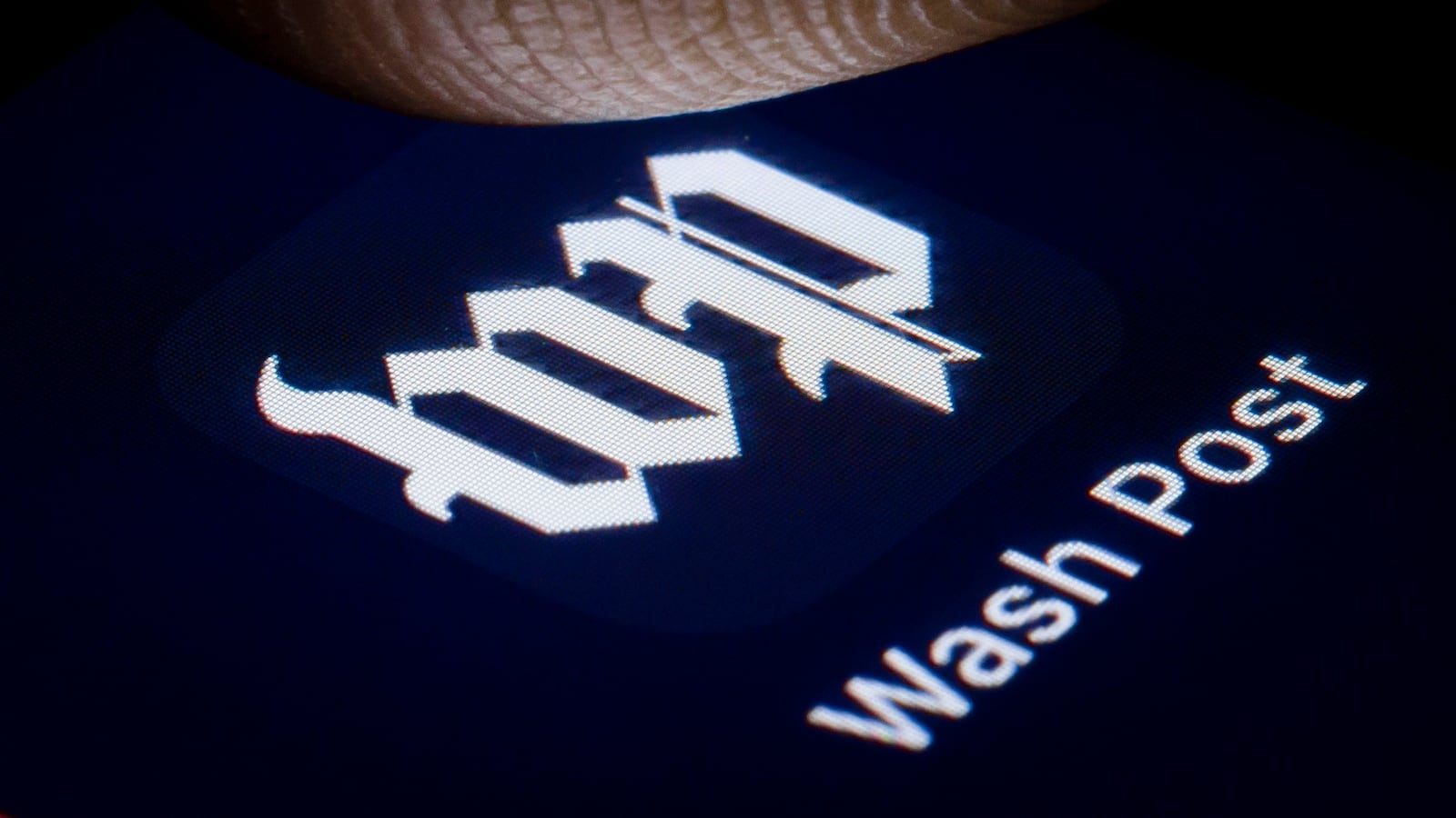 In this photo illustration the logo of major American daily newspaper The Washington Post is displayed on a smartphone