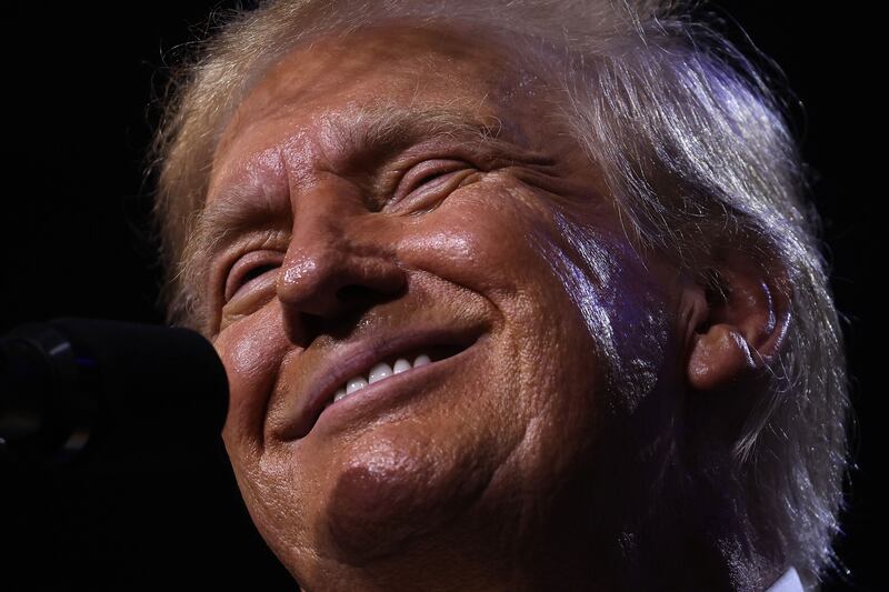 A close up of Donald Trump smiling.