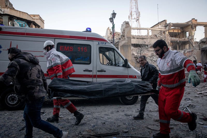 Rescue workers carry a casualty of an Israel and U.S. strike on a police station in Tehran, Iran, March 3, 2026. Majid Khahi/ISNA/WANA (West Asia News Agency) via REUTERS ATTENTION EDITORS - THIS PICTURE WAS PROVIDED BY A THIRD PARTY