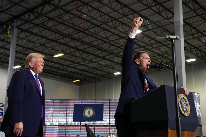 Republican Kentucky congressional candidate Ed Gallrein speaks as President Donald Trump looks during an event at Verst Logistics on March 11, 2026 in Hebron, Kentucky.