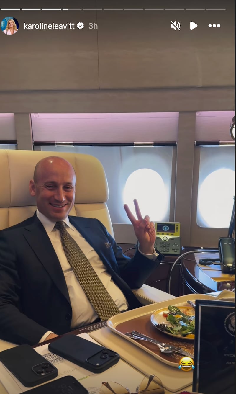 Miller awkwardly threw up the peace sign.