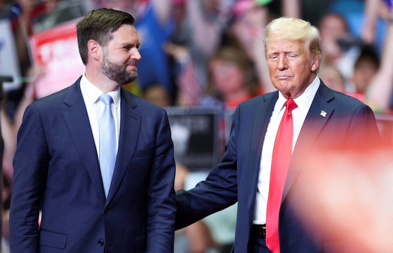Republican presidential nominee and former U.S. President Donald Trump stands with Republican vice presidential nominee U.S. Senator J.D. Vance (R-OH), as he holds a rally for the first time with his running mate, in Grand Rapids, Michigan, U.S. July 20, 2024. REUTERS/Tom Brenner  REFILE - QUALITY REPEAT
