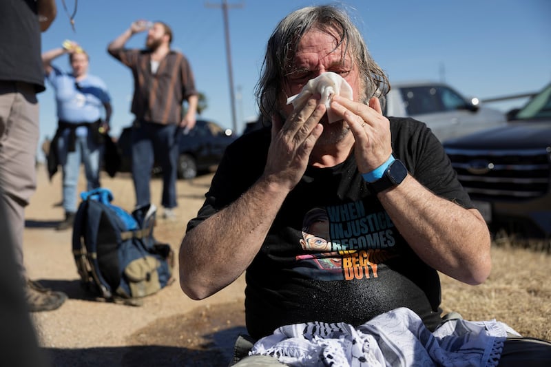 A protestor wipes their face after officers deployed a pepper ball canister during a protest at the South Texas Family Residential Center, where Adrian Conejo and his son Liam Conejo Ramos, who were detained by U.S. Immigration and Customs Enforcement (ICE) agents in Minnesota, are currently being held at the Dilley Immigration Processing Center, in Dilley, Texas, U.S., January 28, 2026.