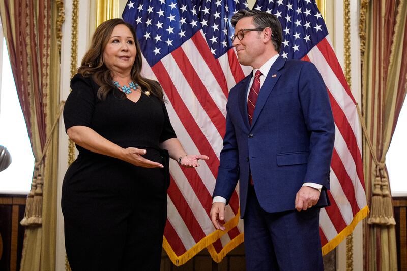 U.S. Rep. Adelita Grijalva (D-AZ), accompanied by Speaker of the House Mike Johnson (R-LA), gestures in response to a reporter's question during a ceremonial swearing-in at the U.S. Capitol Building on November 12, 2025 in Washington, DC.