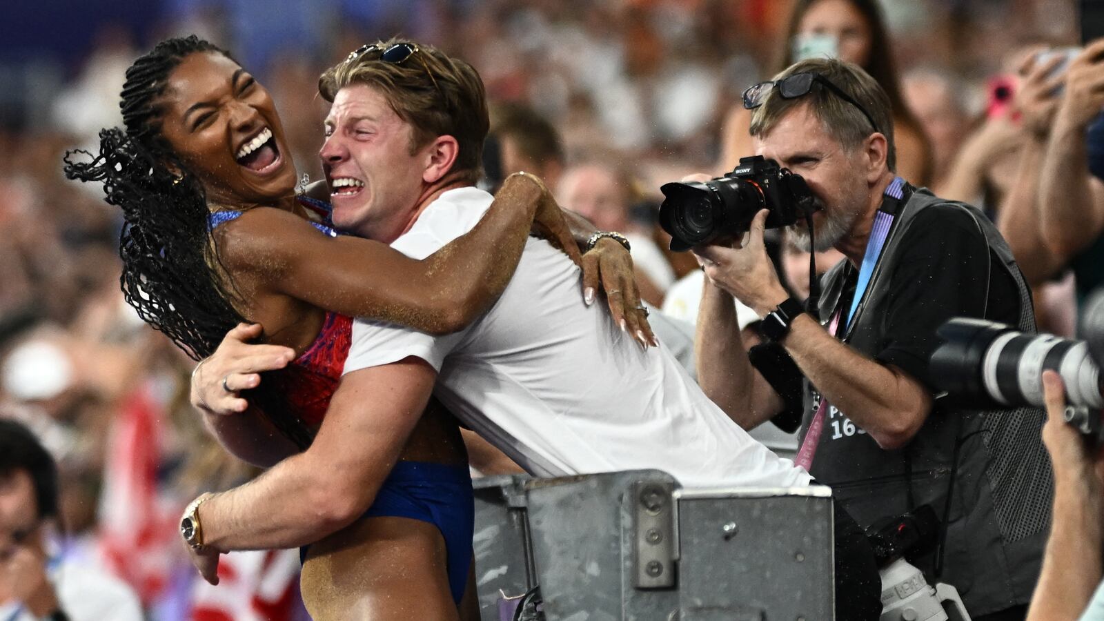 Tara Davis-Woodhall celebrates with her husband Hunter Woodhall after winning gold.