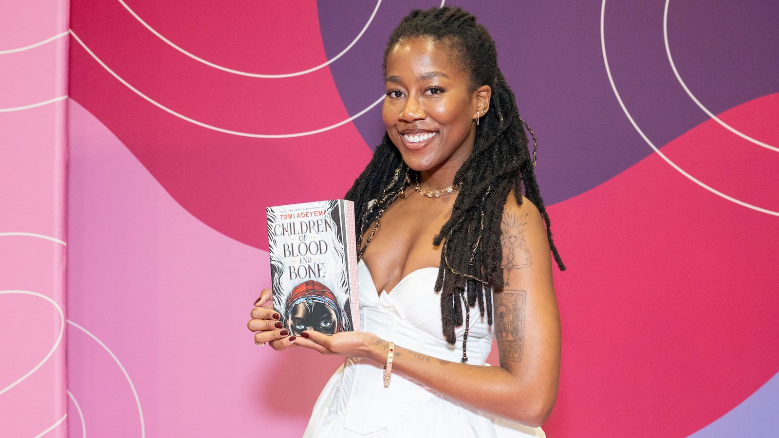 Tomi Adeyemi, #1 New York Times Best-Selling Author poses with her book, "Children of Blood and Bone" during 2025 Pennsylvania Conference For Women at Pennsylvania Convention Center on September 25, 2025 in Philadelphia.