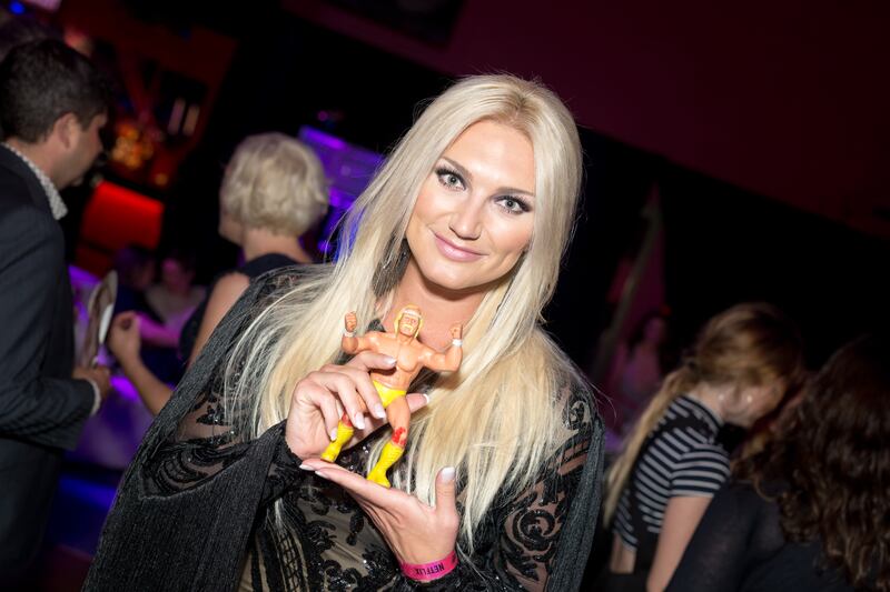 Actress Brooke Hogan poses with a Hulk Hogan figurine