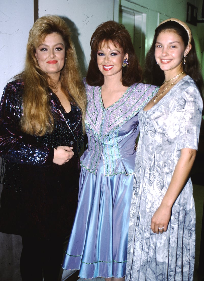 Wynonna, left, and Ashley, right, have the same mother, Naomi, center, but different fathers.
