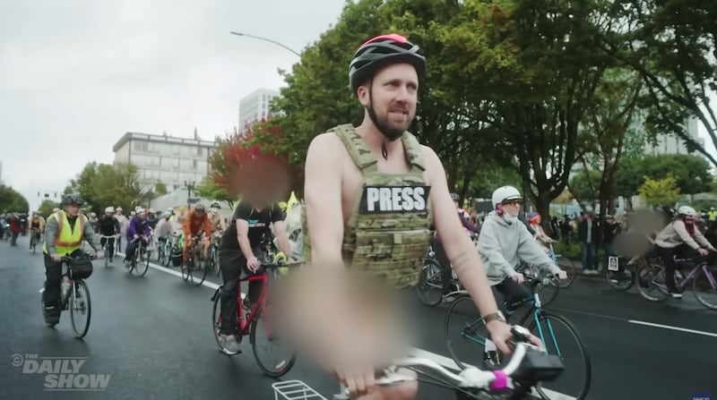 Jordan Klepper Fingers the Pulse, Klepper at a naked bike ride protest.