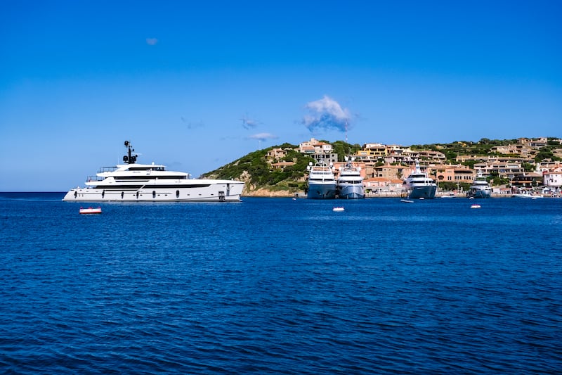 A luxury yacht arrives in the marina of Porto Cervo, a upper scale town on the northern coast of Sardinia.