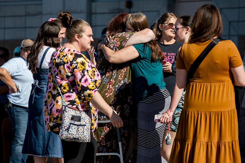 Church members and residents reunite at Trillium Theater located across the street from the site of a shooting and fire at the Church of Jesus Christ of Latter-day Saints on September 28, 2025 in Grand Blanc, Michigan. According to police reports there are multiple victims and the shooter is down. (Photo by Emily Elconin/Getty Images)