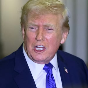 President Donald Trump speaks to reporters while in flight on Air Force One, en route Joint Base Andrews from West Palm Beach, Florida on February 16, 2026.