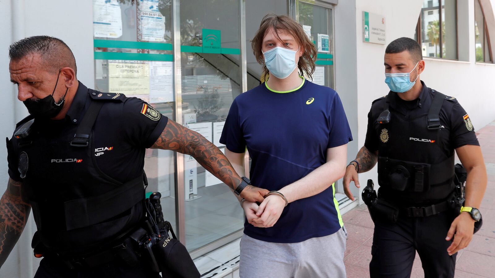 Joseph James O'Connor is led by Spanish police officers as he leaves a court after being arrested in connection with an alleged July 2020 Twitter hack in Estepona, Spain, July 22, 2021.